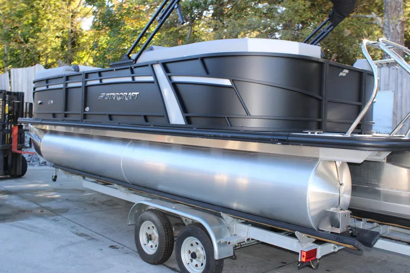 Slide: The Image of 2026 Starcraft EXS 3 pontoon boat on trailer, sleek black design. - 3