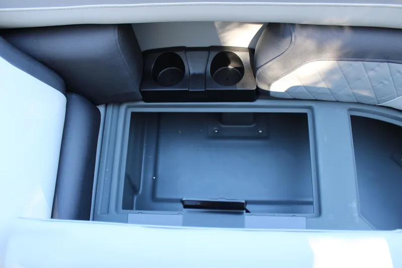 Slide: The Image of Interior storage compartment of 2026 Starcraft EXS 3 with cup holders and quilted seating. - 32
