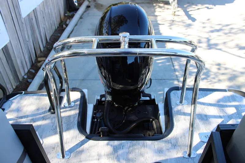 Slide: The Image of Starcraft EXS 3 2026 boat engine with chrome railing in a sunny outdoor setting. - 8