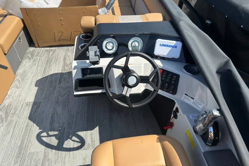 Slide: The Image of 2025 Crest Classic 240 boat dashboard with steering wheel and navigation instruments. - 6