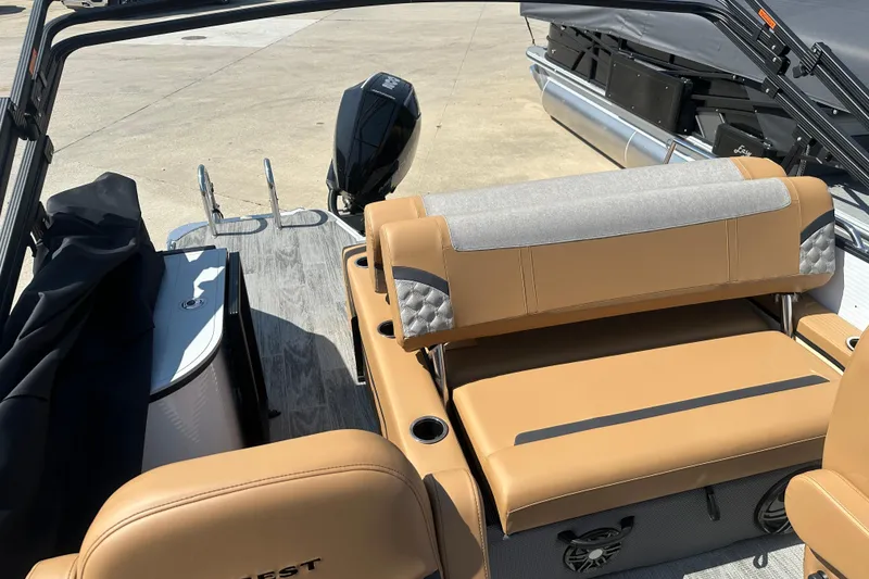 Slide: The Image of 2025 Crest Classic 240 boat interior with tan seating and modern design. - 8