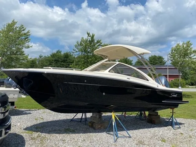 The Image of 2021 Scout 235 Dorado boat on display outdoors, under a partly cloudy sky. - 0