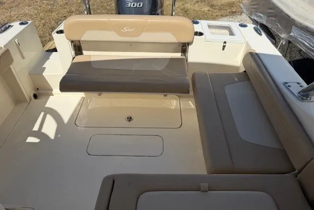 Slide: The Image of 2021 Scout 235 Dorado boat interior with beige seating and storage compartments. - 10