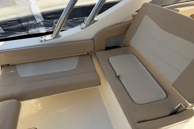 Slide: The Image of 2021 Scout 235 Dorado boat interior with beige seating and stainless steel accents. - 11