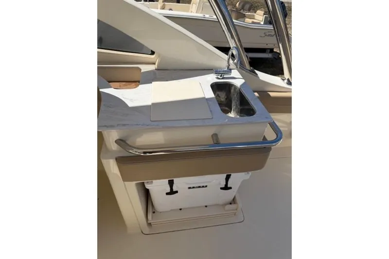 Slide: The Image of 2021 Scout 235 Dorado boat interior with sink and storage compartment. - 13