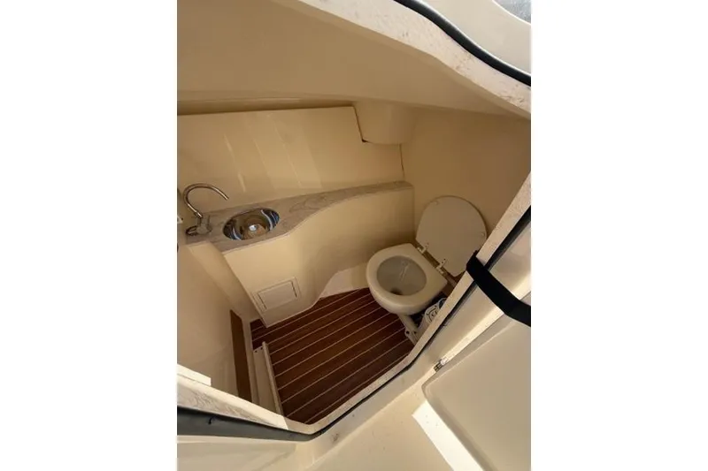 Slide: The Image of 2021 Scout 235 Dorado boat interior bathroom with sink and toilet. - 3