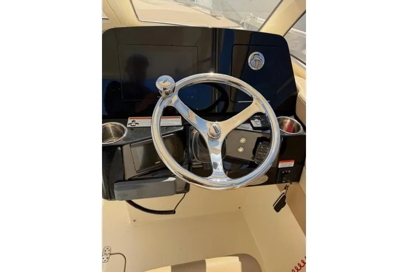 Slide: The Image of Steering wheel of a 2021 Scout 235 Dorado boat, featuring a sleek dashboard design. - 5