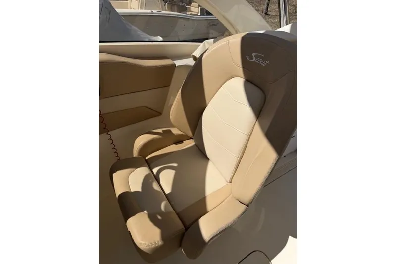 Slide: The Image of Beige leather seat in 2021 Scout 235 Dorado boat, sunlight casting shadows. - 6