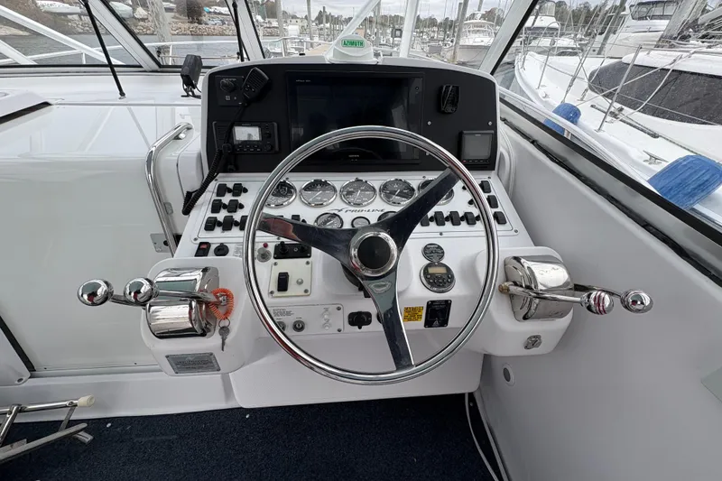 Slide: The Image of 2005 Pro-Line 33 Express boat helm with steering wheel and control panel. - 11