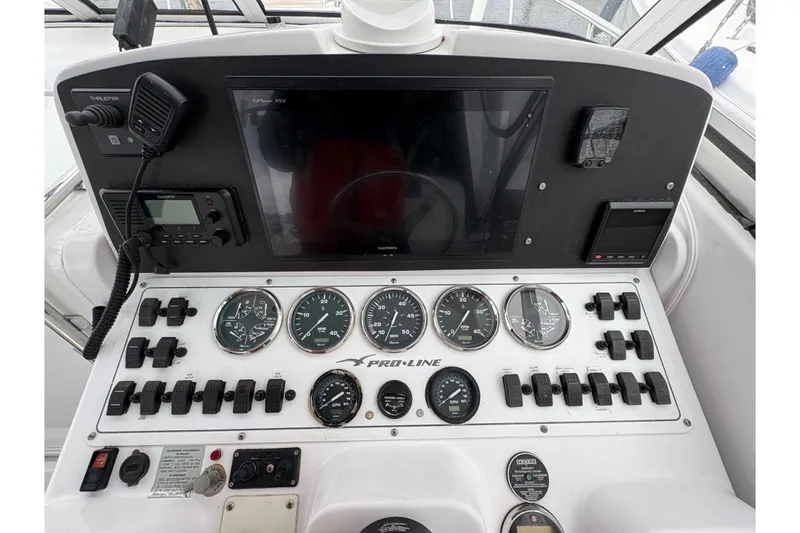 Slide: The Image of 2005 Pro-Line 33 Express boat dashboard with gauges and controls. - 12