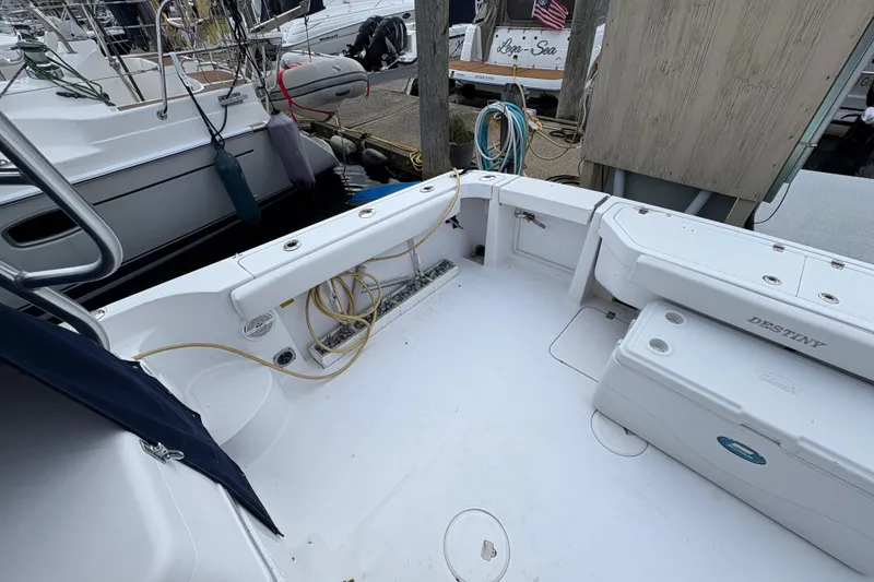 Slide: The Image of 2005 Pro-Line 33 Express boat deck with storage and seating at marina. - 13