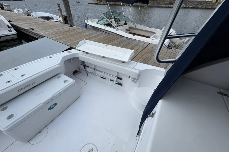 Slide: The Image of 2005 Pro-Line 33 Express boat docked, featuring spacious deck and seating area. - 14