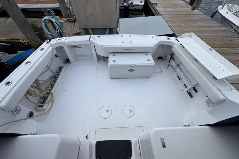 Slide: The Image of 2005 Pro-Line 33 Express boat deck with fishing rods and storage compartments. - 15