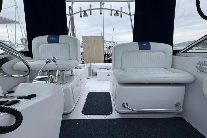 Slide: The Image of 2005 Pro-Line 33 Express boat interior with white seating and control panel. - 16