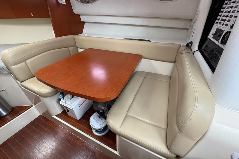 Slide: The Image of 2005 Pro-Line 33 Express cabin with beige seating and wooden table. - 18