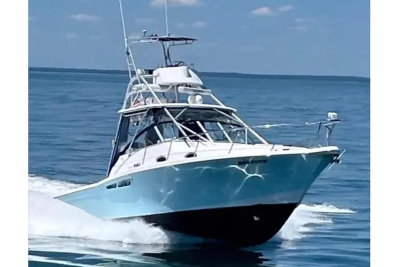 Slide: The Image of 2005 Pro-Line 33 Express boat cruising on open water. - 2