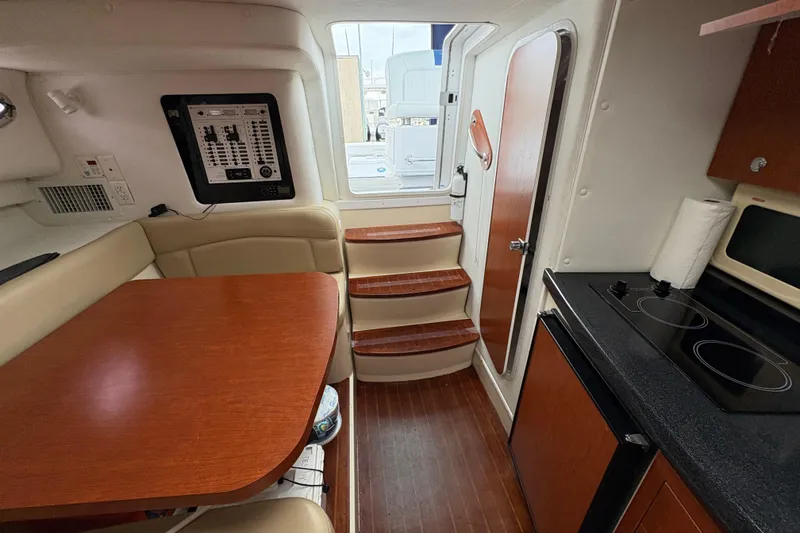 Slide: The Image of 2005 Pro-Line 33 Express cabin interior with kitchenette, seating, and stairs to deck. - 22