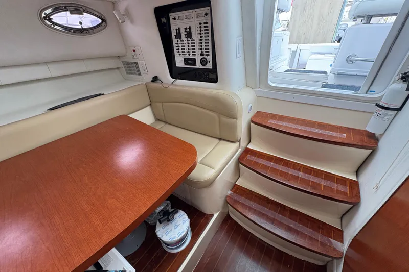 Slide: The Image of 2005 Pro-Line 33 Express cabin interior with seating, table, and wooden steps. - 24