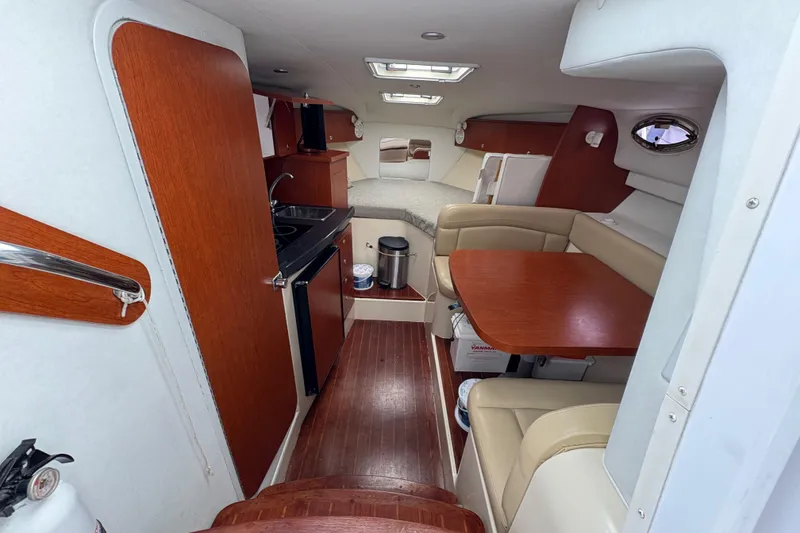 Slide: The Image of 2005 Pro-Line 33 Express cabin interior with kitchenette, seating, and sleeping area. - 27