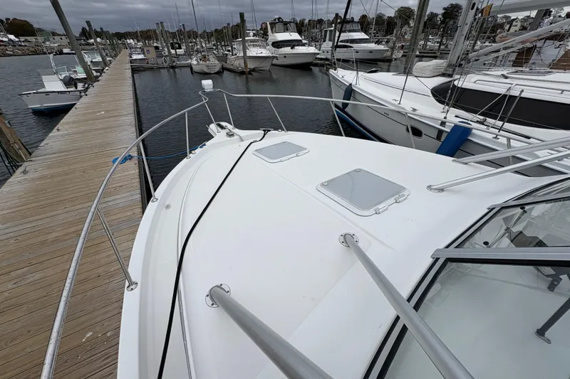 Slide: The Image of 2005 Pro-Line 33 Express boat docked at marina with other vessels. - 28