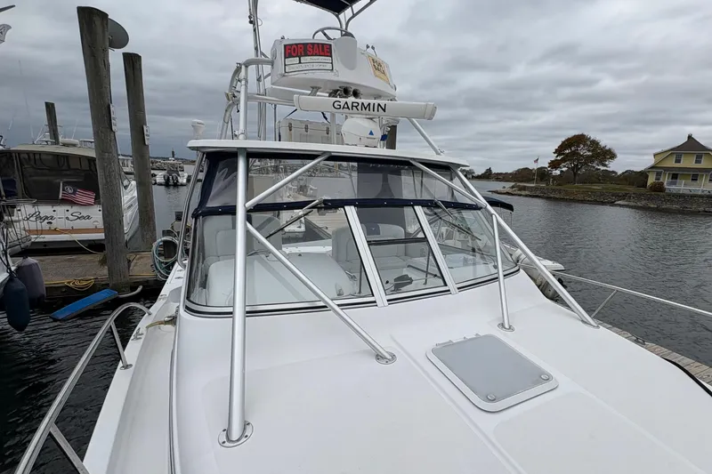 Slide: The Image of 2005 Pro-Line 33 Express boat docked, featuring a "For Sale" sign and Garmin equipment. - 33