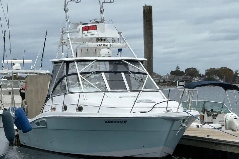 Slide: The Image of 2005 Pro-Line 33 Express boat docked, with "For Sale" sign and Garmin equipment. - 35