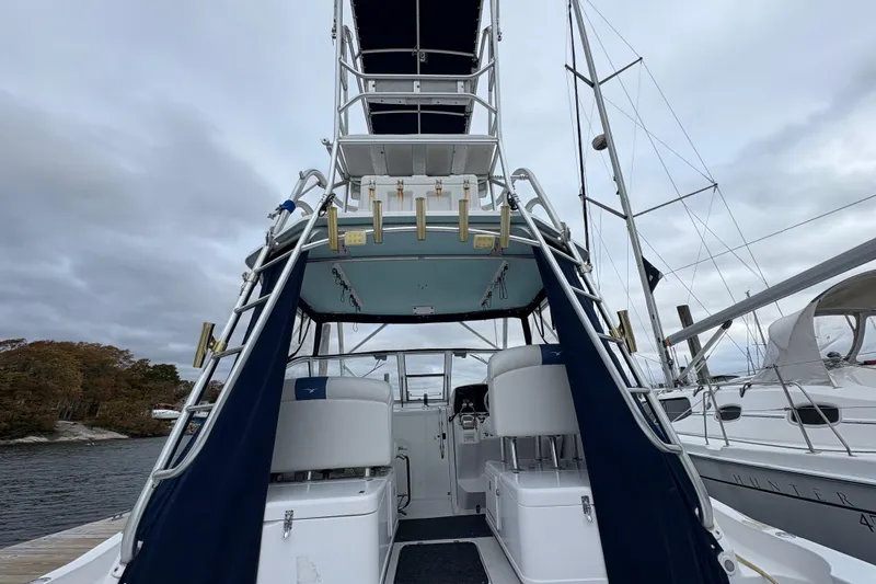 Slide: The Image of 2005 Pro-Line 33 Express boat with tower, docked under cloudy skies. - 4