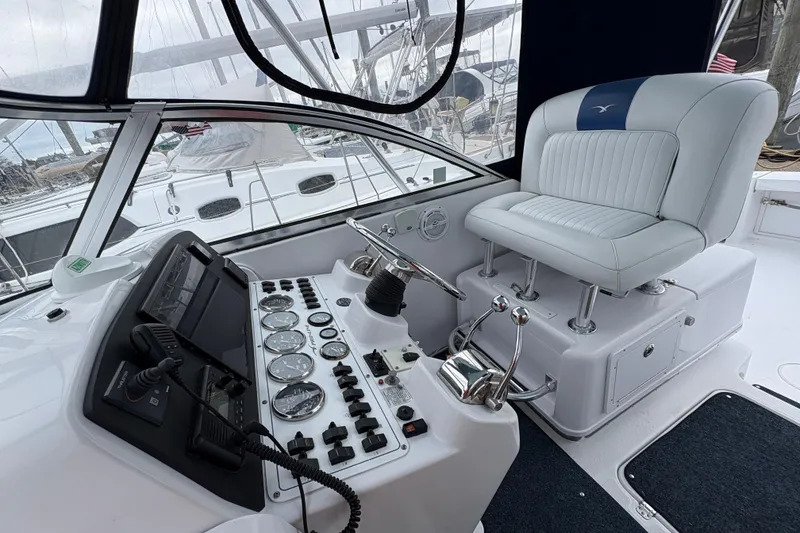 Slide: The Image of 2005 Pro-Line 33 Express boat cockpit with control panel and captain's chair. - 6