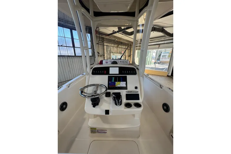 Slide: The Image of 2025 Grady-White Fisherman 216 boat console with steering wheel and navigation display. - 6