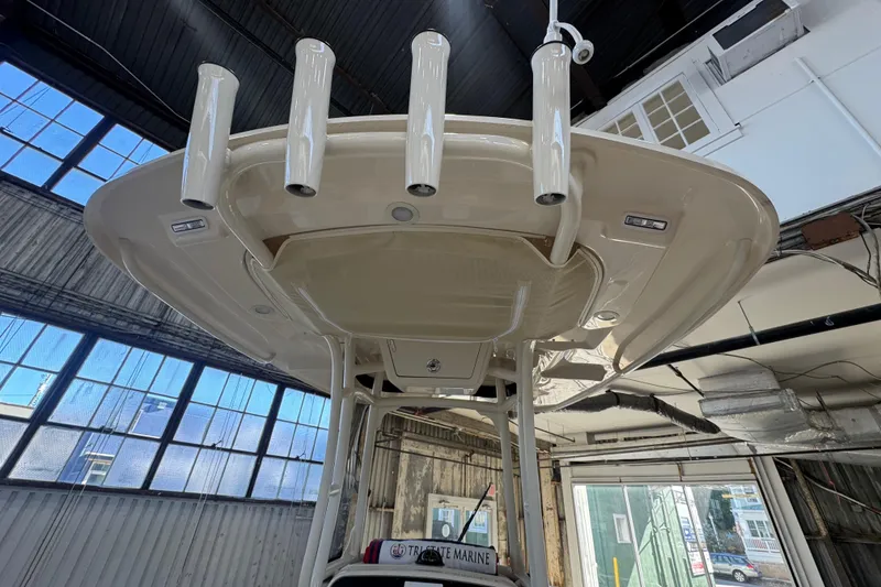 Slide: The Image of 2025 Grady-White Fisherman 216 boat interior, showcasing rod holders and overhead design. - 7