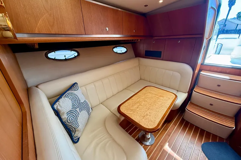Slide: The Image of 2005 Tiara 3600 Open yacht interior with wood finish and cozy seating area. - 14