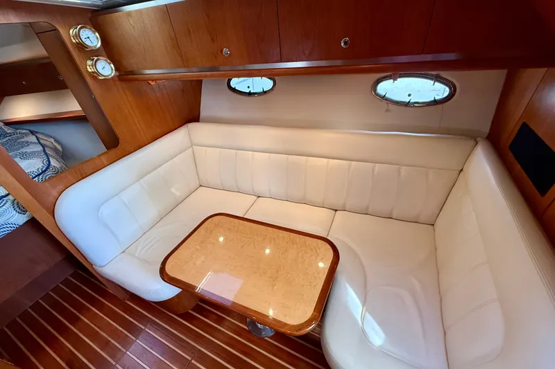 Slide: The Image of Luxurious interior of 2005 Tiara Yachts 3600 Open with cozy seating and elegant wood finishes. - 15