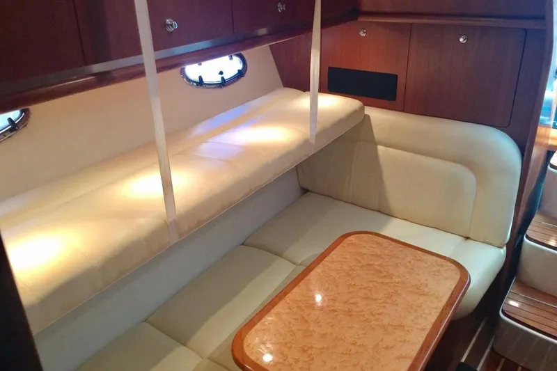 Slide: The Image of Luxurious 2005 Tiara 3600 Open yacht interior with elegant seating and wooden accents. - 16