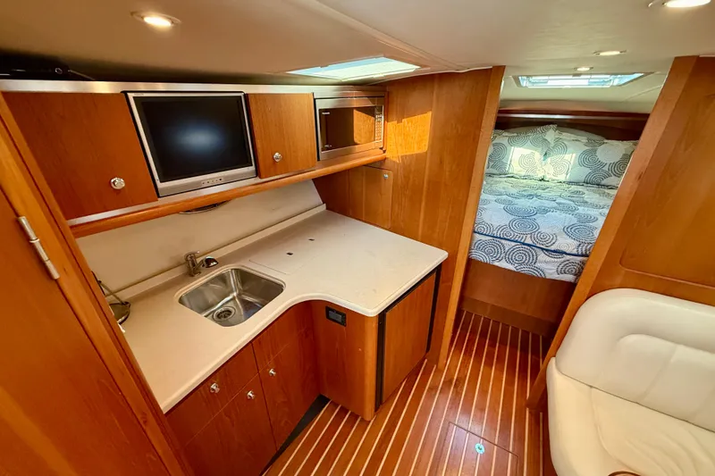 Slide: The Image of Luxurious interior of 2005 Tiara Yachts 3600 Open with white seating and wooden accents. - 17