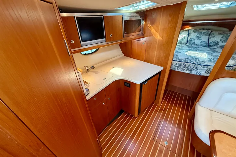 Slide: The Image of 2005 Tiara Yachts 3600 Open interior with cozy seating and elegant wood finishes. - 18