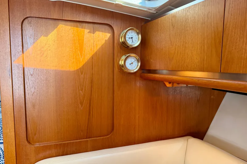 Slide: The Image of 2005 Tiara 3600 Open yacht interior with kitchenette, featuring wood cabinetry and modern appliances. - 21