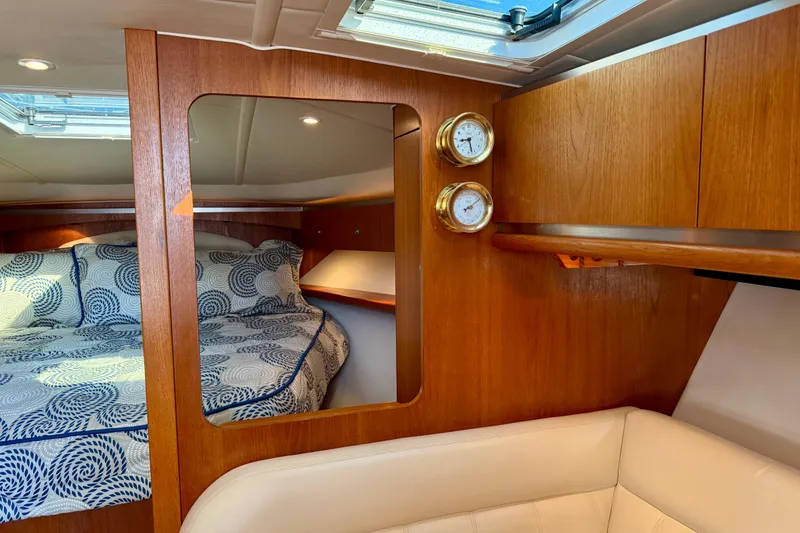 Slide: The Image of Open mini fridge in 2005 Tiara 3600 Open yacht interior, wooden flooring visible. - 22