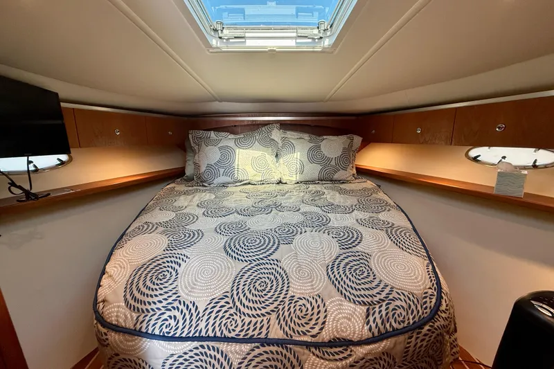 Slide: The Image of Interior of 2005 Tiara Yachts 3600 Open with wooden paneling and brass instruments. - 23