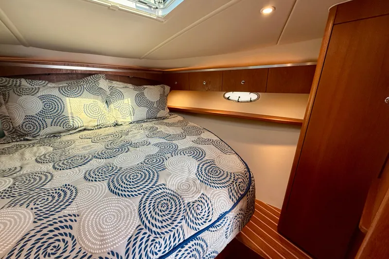 Slide: The Image of 2005 Tiara Yachts 3600 Open cabin interior with wood paneling and nautical decor. - 24