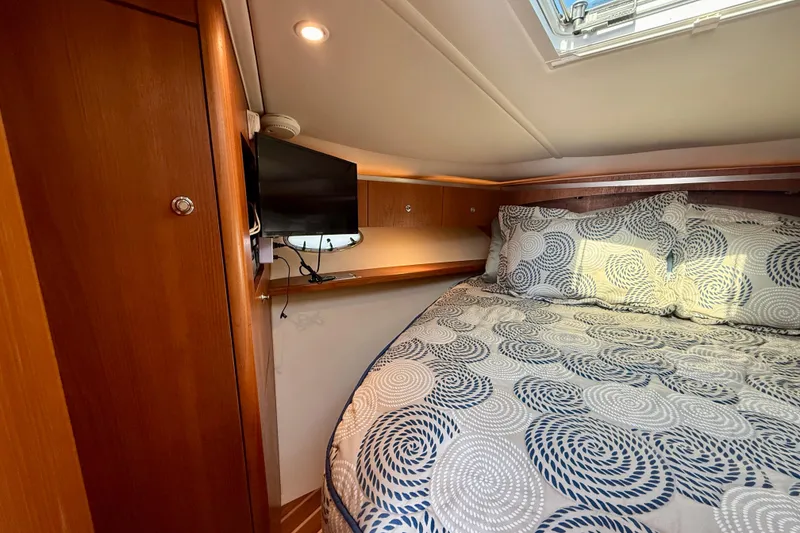 Slide: The Image of Luxurious cabin interior of 2005 Tiara 3600 Open yacht with patterned bedding. - 25
