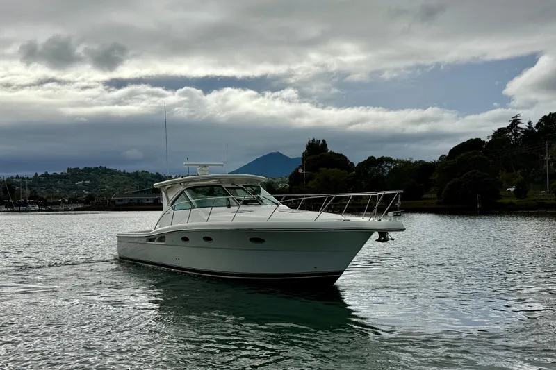 Slide: The Image of 2005 Tiara 3600 Open yacht on calm water, surrounded by trees and mountains. - 5