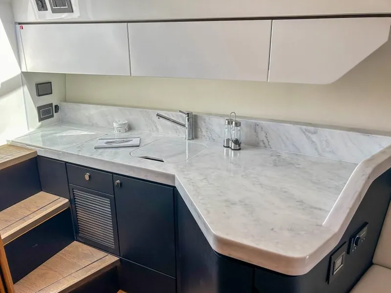 Slide: The Image of Modern kitchen area in 2023 Fairline F//Line 33 Outboard yacht with marble countertop. - 12