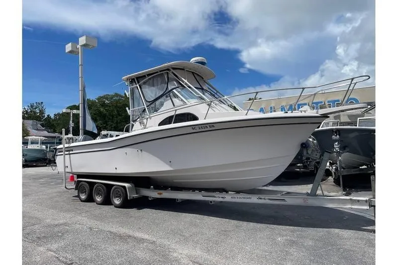 The Image of 2004 Grady-White Sailfish 282 boat on trailer under cloudy sky. - 0
