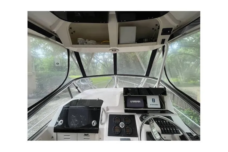 Slide: The Image of 2004 Grady-White Sailfish 282 boat cockpit with navigation equipment and steering wheel. - 3