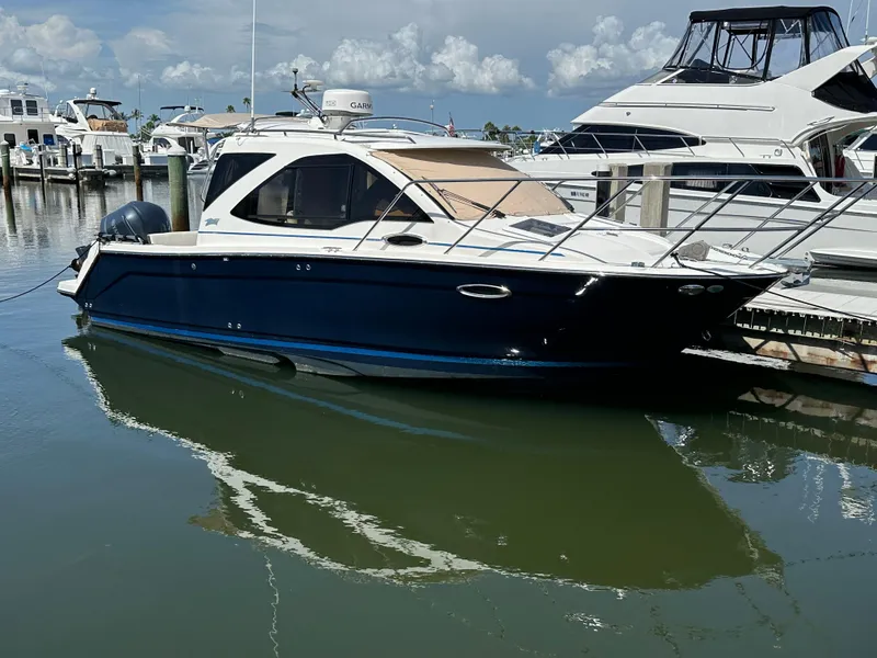 The Image of 2016 Cutwater C 24 Coupe docked at marina, reflecting on calm water. - 0