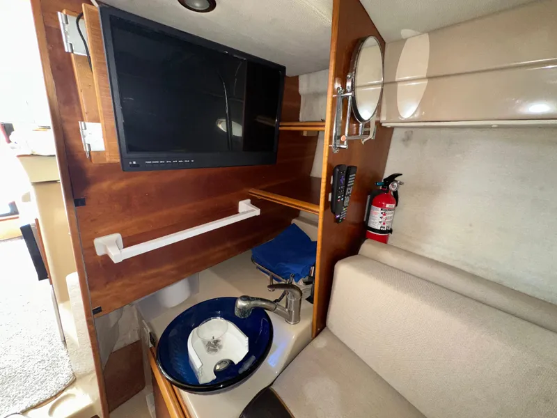 Slide: The Image of 2016 Cutwater C 24 Coupe interior with TV, sink, and fire extinguisher. - 15