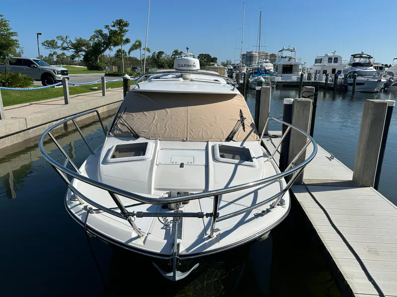 Slide: The Image of 2016 Cutwater C 24 Coupe docked at marina under clear blue sky. - 2