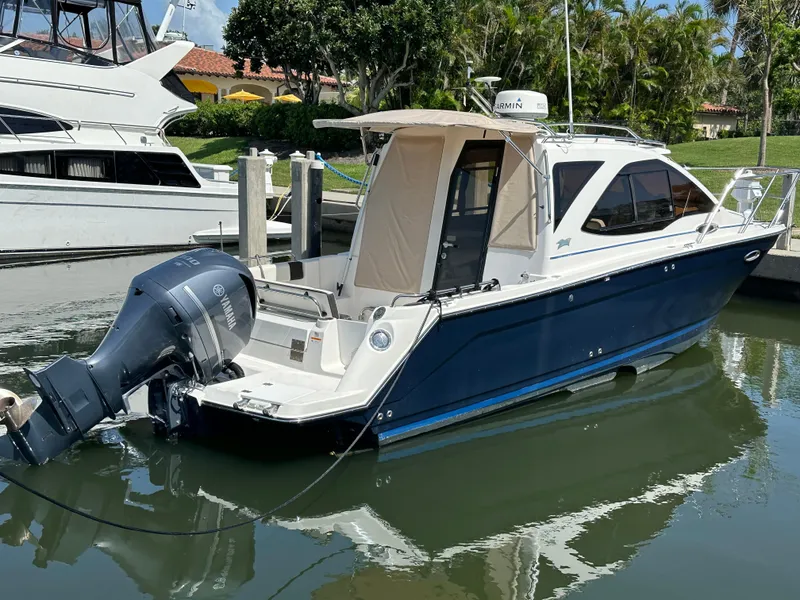 Slide: The Image of 2016 Cutwater C 24 Coupe boat docked, featuring a Yamaha outboard motor. - 4