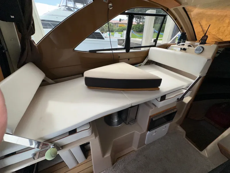 Slide: The Image of Interior of a 2016 Cutwater C 24 Coupe boat with convertible seating area. - 9