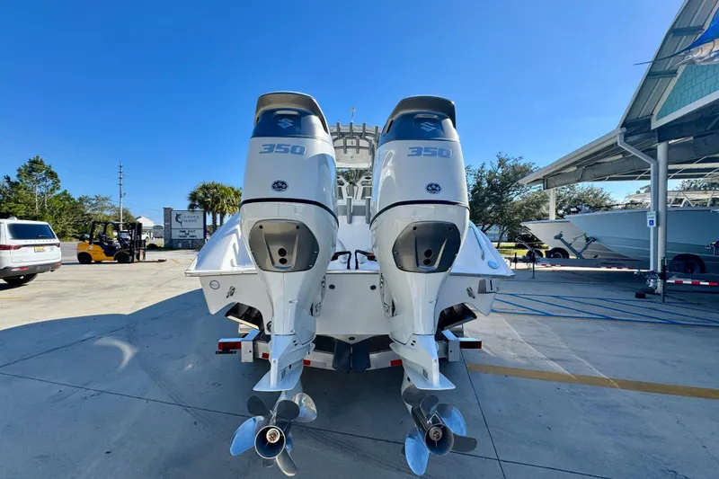 Slide: The Image of 2026 Cape Horn 32 XS boat with dual 350 horsepower engines, parked outdoors. - 15